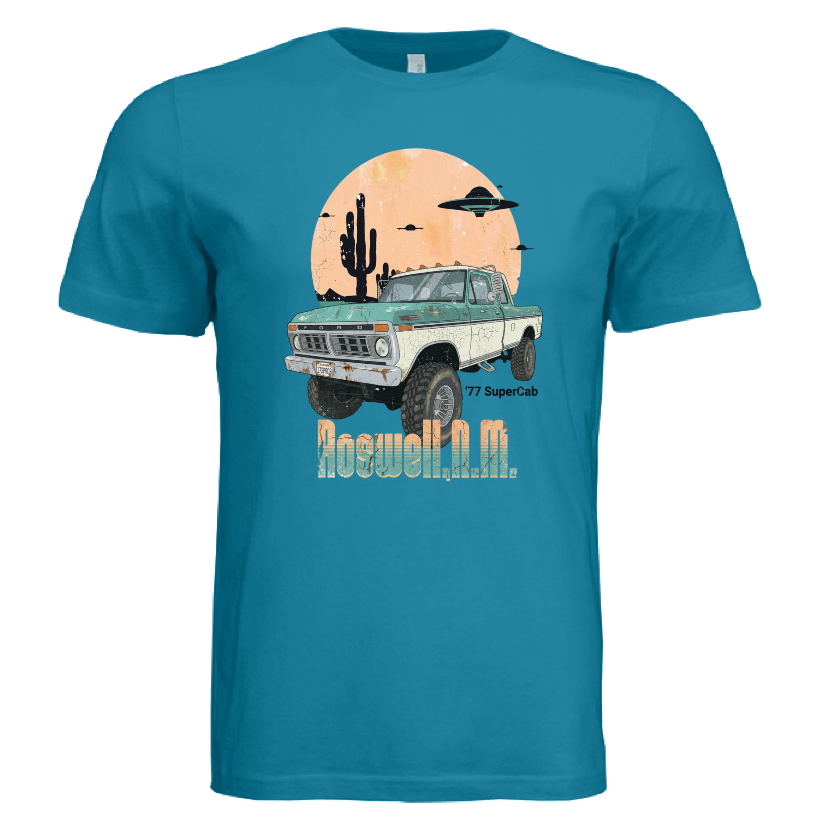 Blue t-shirt with a graphic of a truck and desert scene on a white background