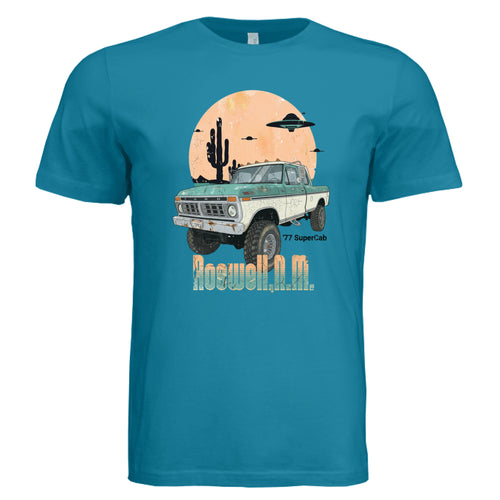 Blue t-shirt with a graphic of a truck and desert scene on a white background