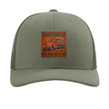 Green cap with a leather patch featuring a truck and 'Barebush Hardwood' text on a white background.